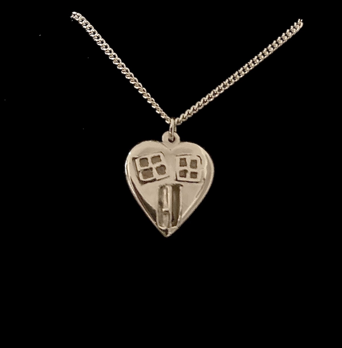 Silver heart with windows and an open door pendant with silver chain