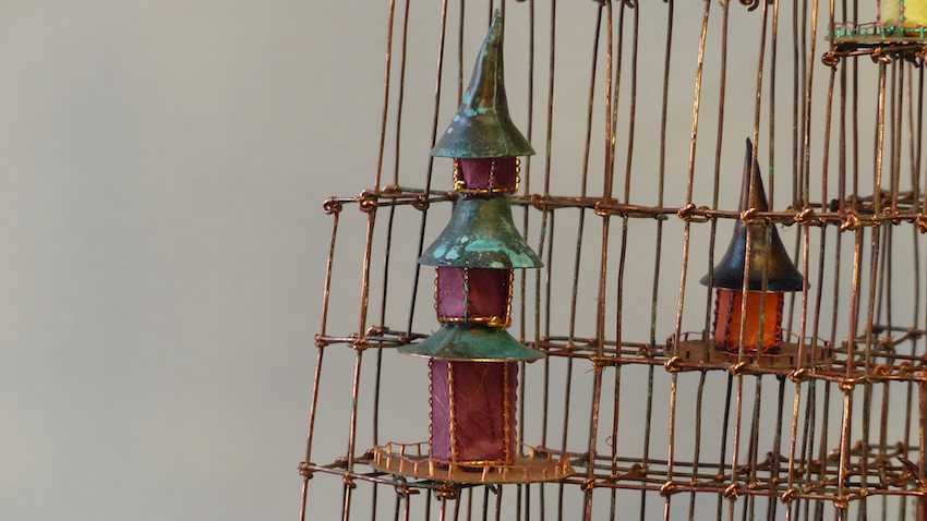 Island with colourful homes on a wire scaffold triple roof close-up