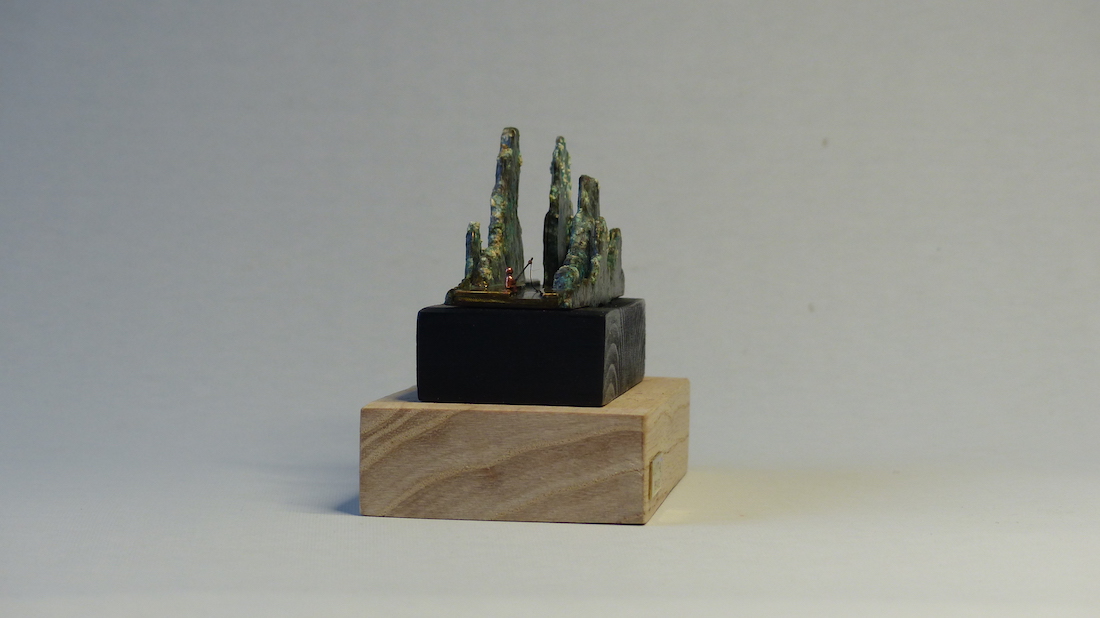 Green patinated brass mountain and fisherman ring sculpture side