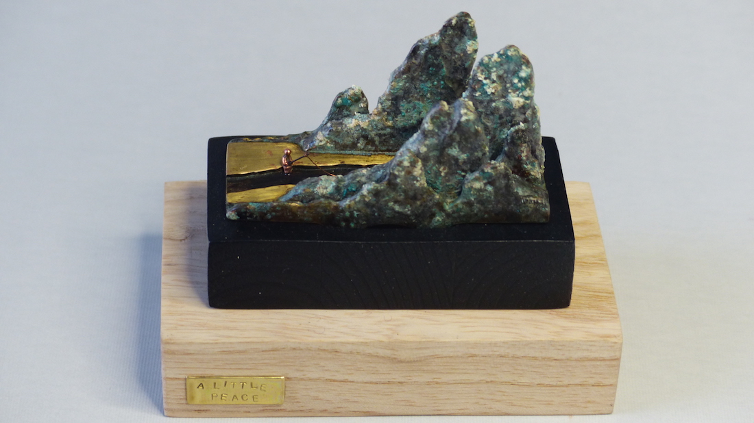 Green patinated brass mountain and fisherman ring sculpture from above