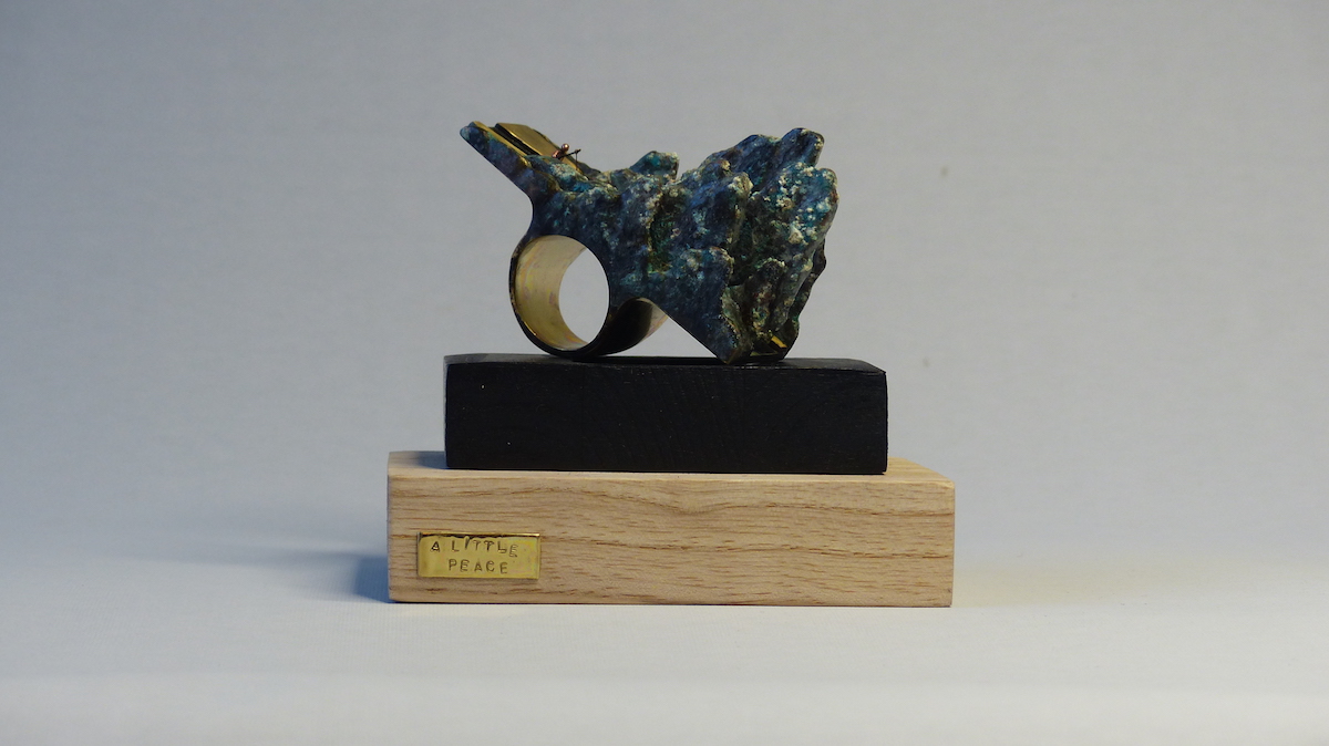 Green patinated brass mountain and fisherman ring sculpture ring display