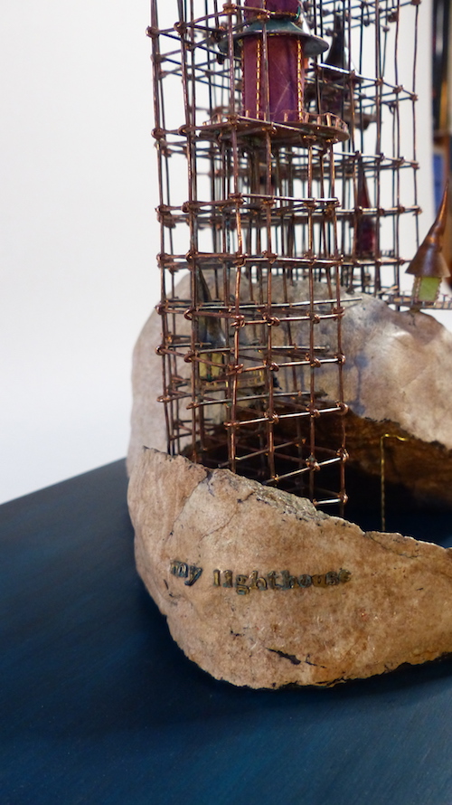 Island with colourful homes on a wire scaffold pier from above