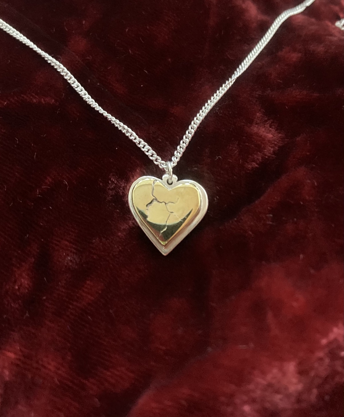 Broken heart pendant with silver base chain