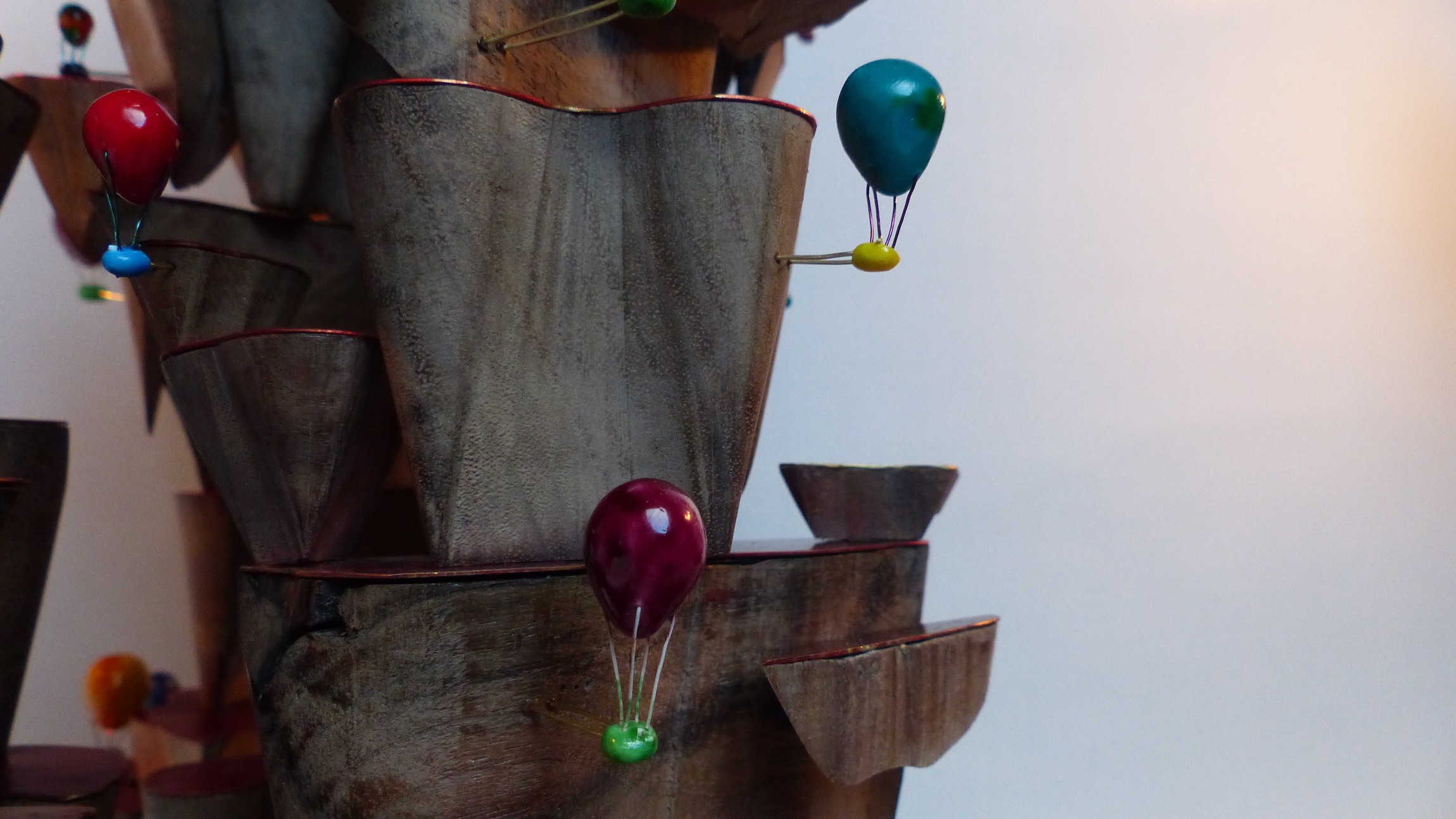 Balloons rising from walnut steps close-up