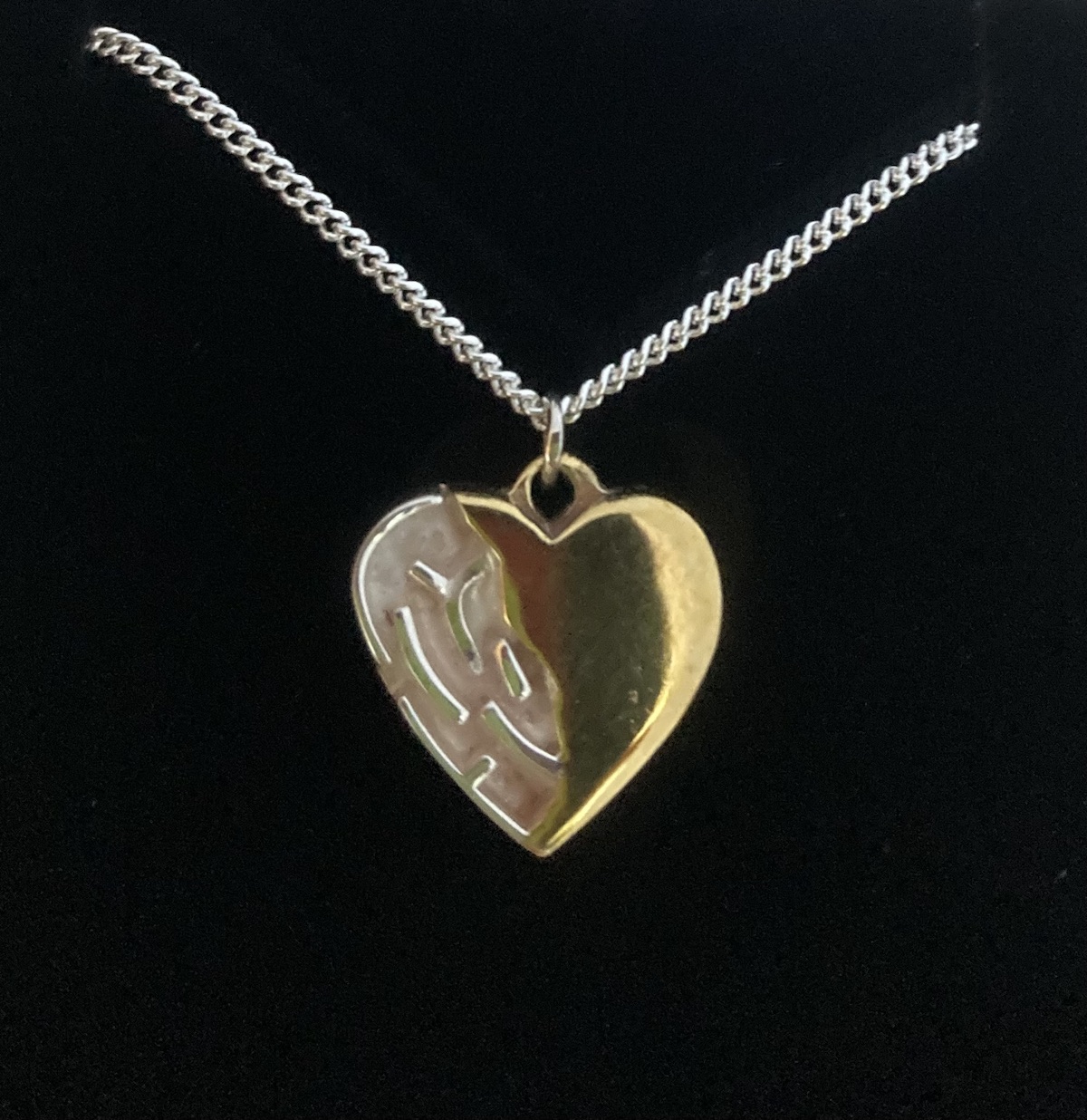 Silver maze and brass heart pendant with silver chain front side