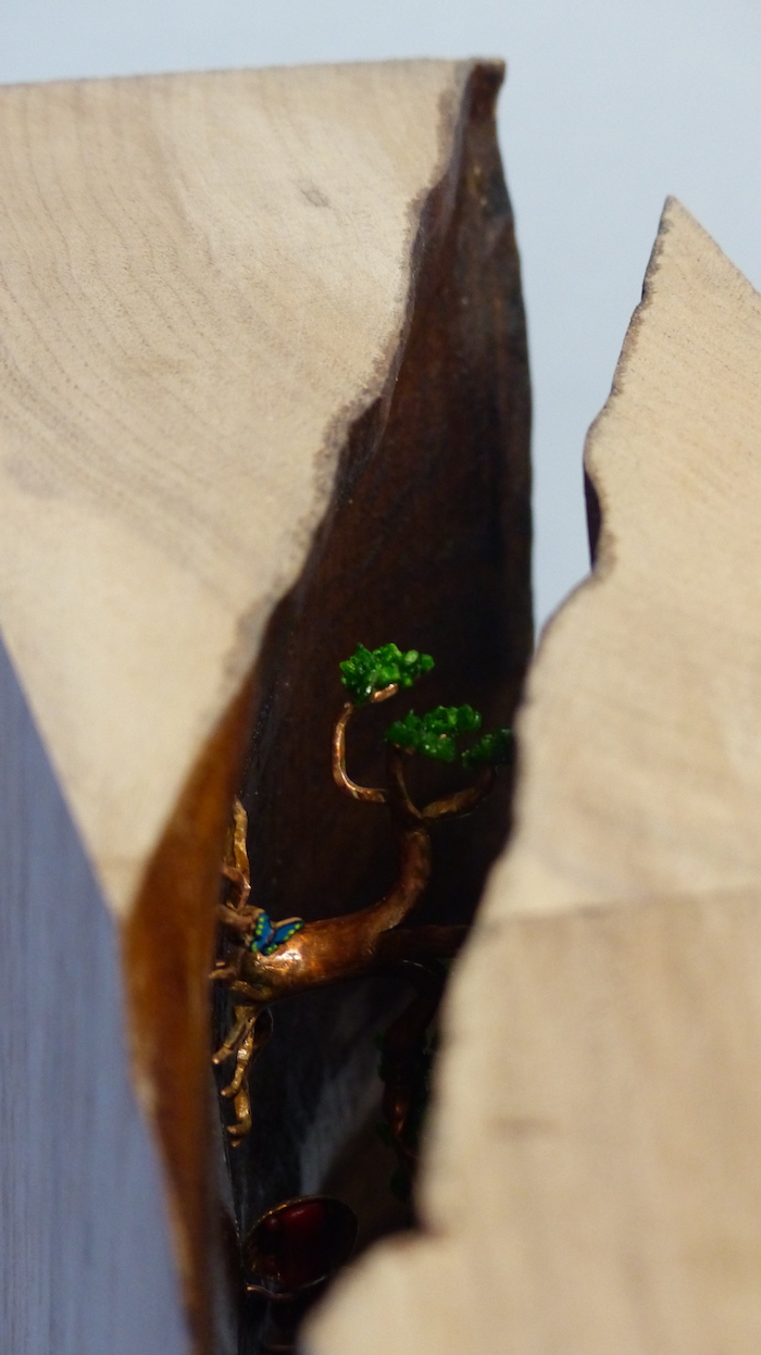 Cracked walnut block filled with brass cells cracked seam close-up from above