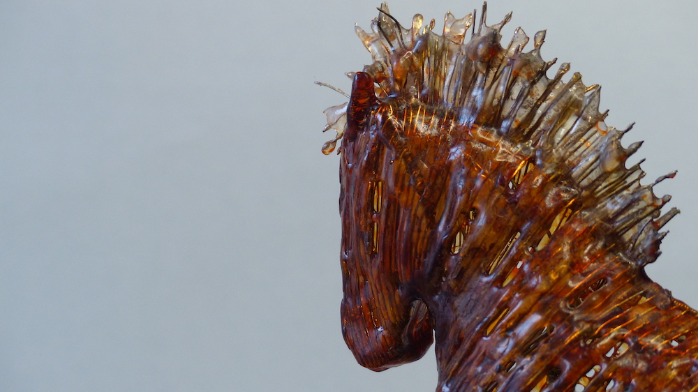 Wire horses - pair of opposites amber horse head close-up