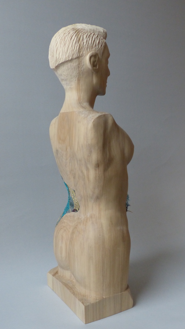 Cream hardwood female sculpture with colourful crochet layers back the the side