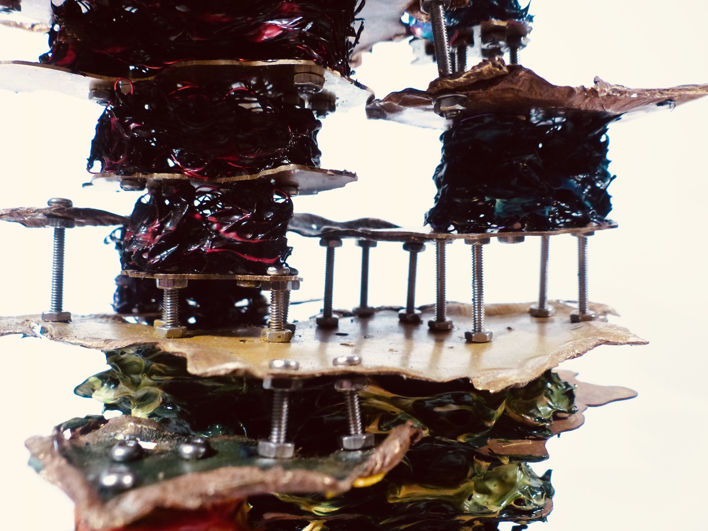 Cracked walnut block filled with brass cells front side high angle