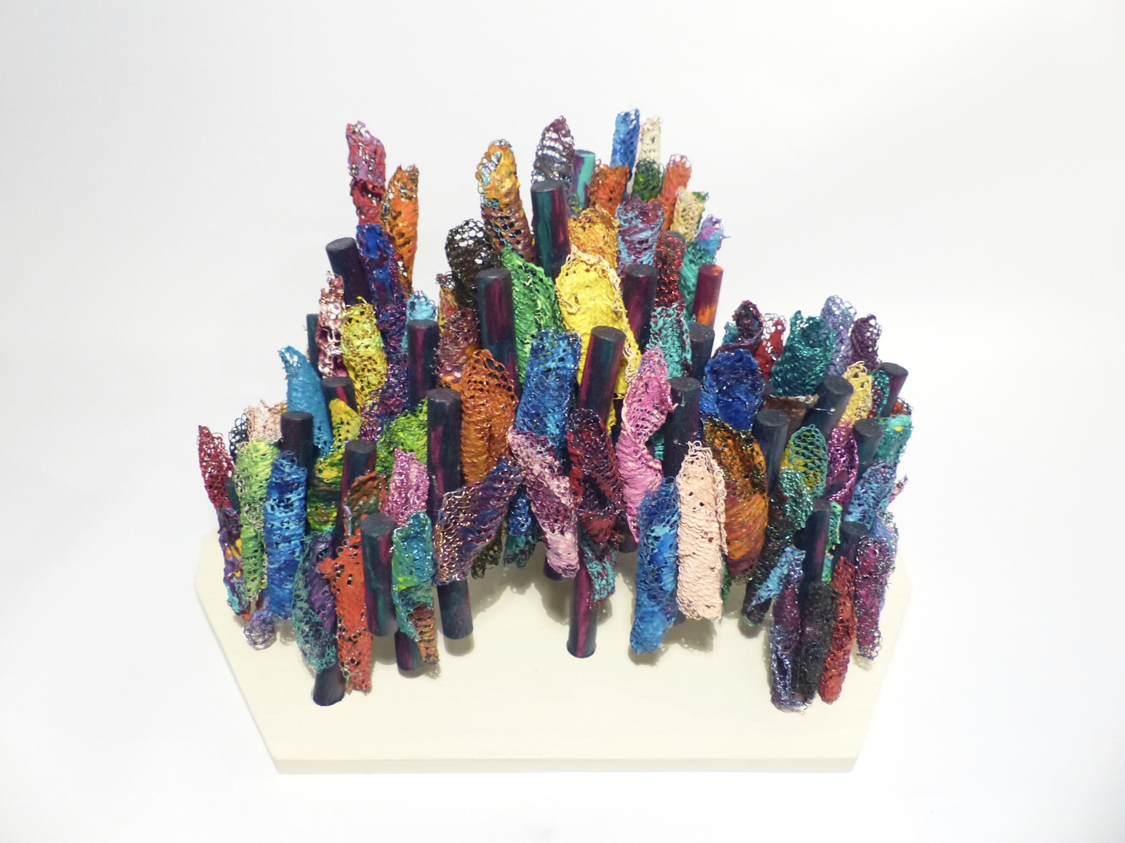 Painted wire crochet scrolls attached to painted pillars growing into a bridge